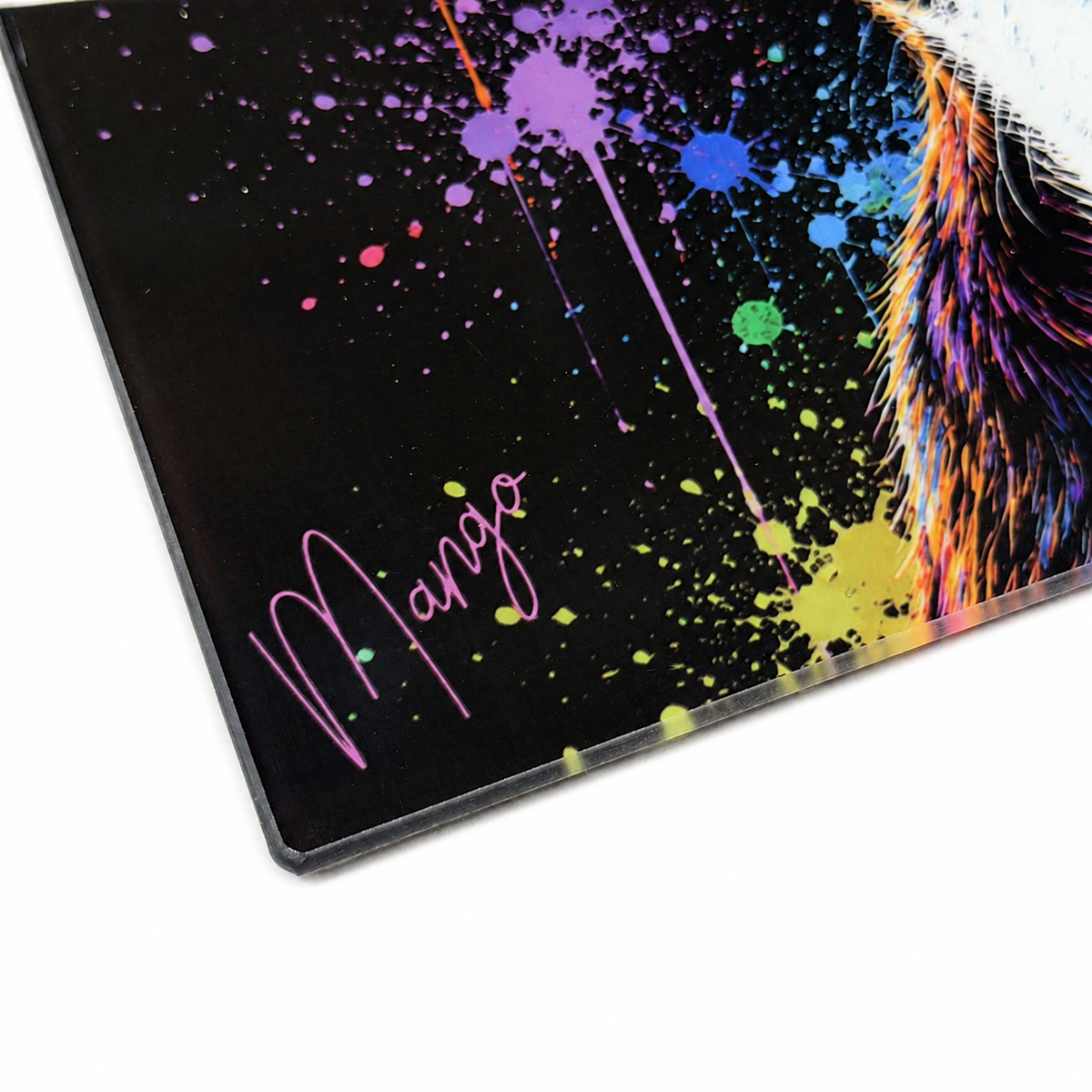 Close-up of the personalised name Mango on a colourful dog glass chopping board.